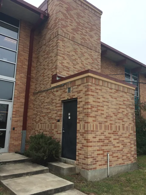 Finished block building with a brick face and steel door