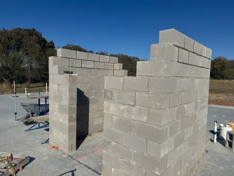 New CMU block building rising under a blue sky