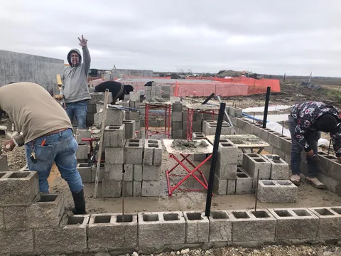 Crew building CMU foundation walls