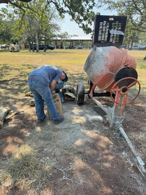 Mason tending a mortar mixer on site