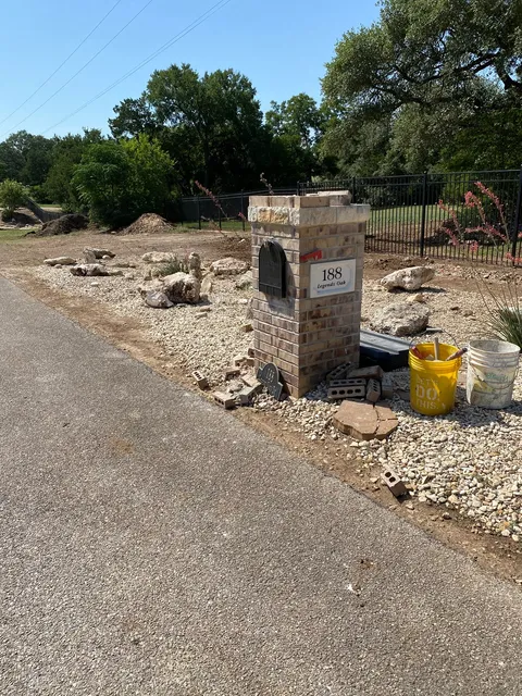 Finished brick mailbox column beside a road