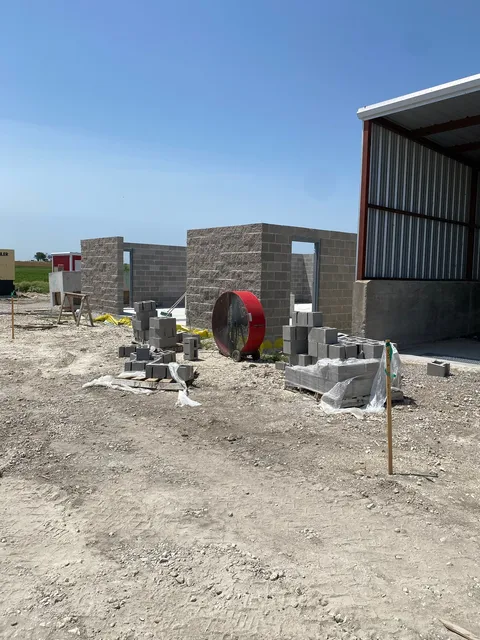 Block pump-station building under a metal canopy