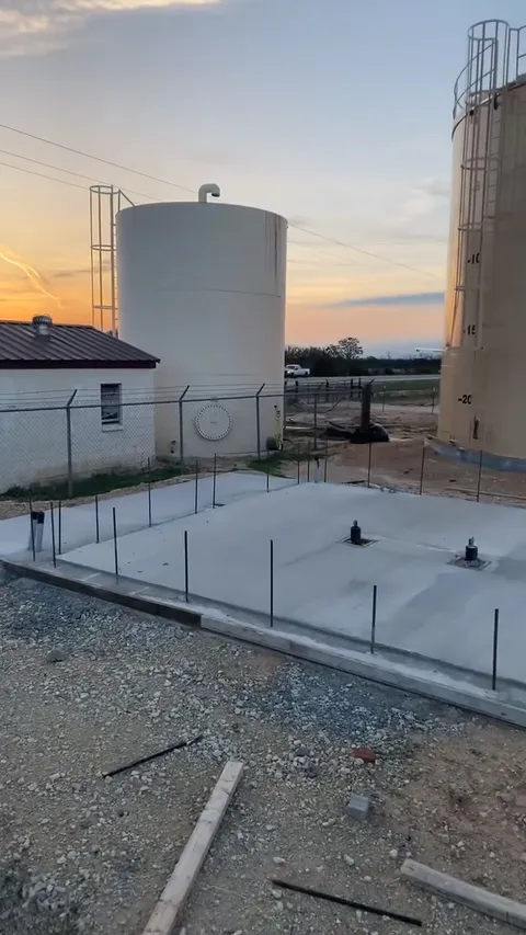 Finished pump-station building and water tanks at sunset