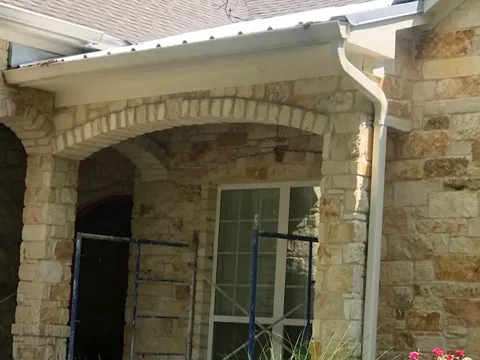 Arched stone porch on a Hill Country home