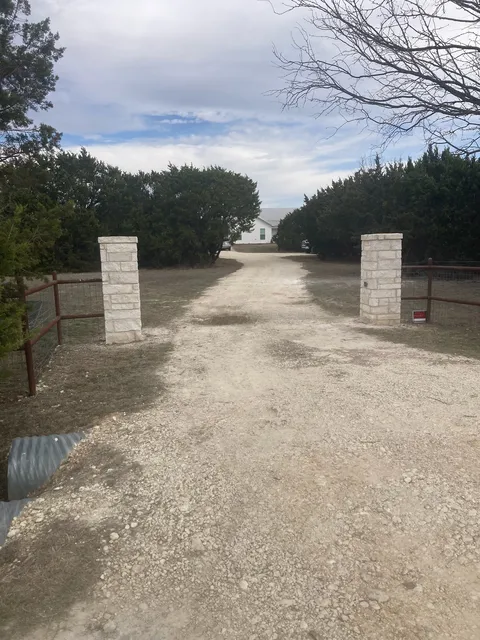 Pair of stone columns flanking a gravel drive