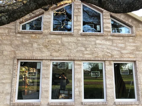 Full stone exterior with a wall of feature windows