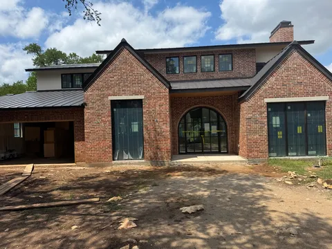 New-construction brick home with black-framed windows